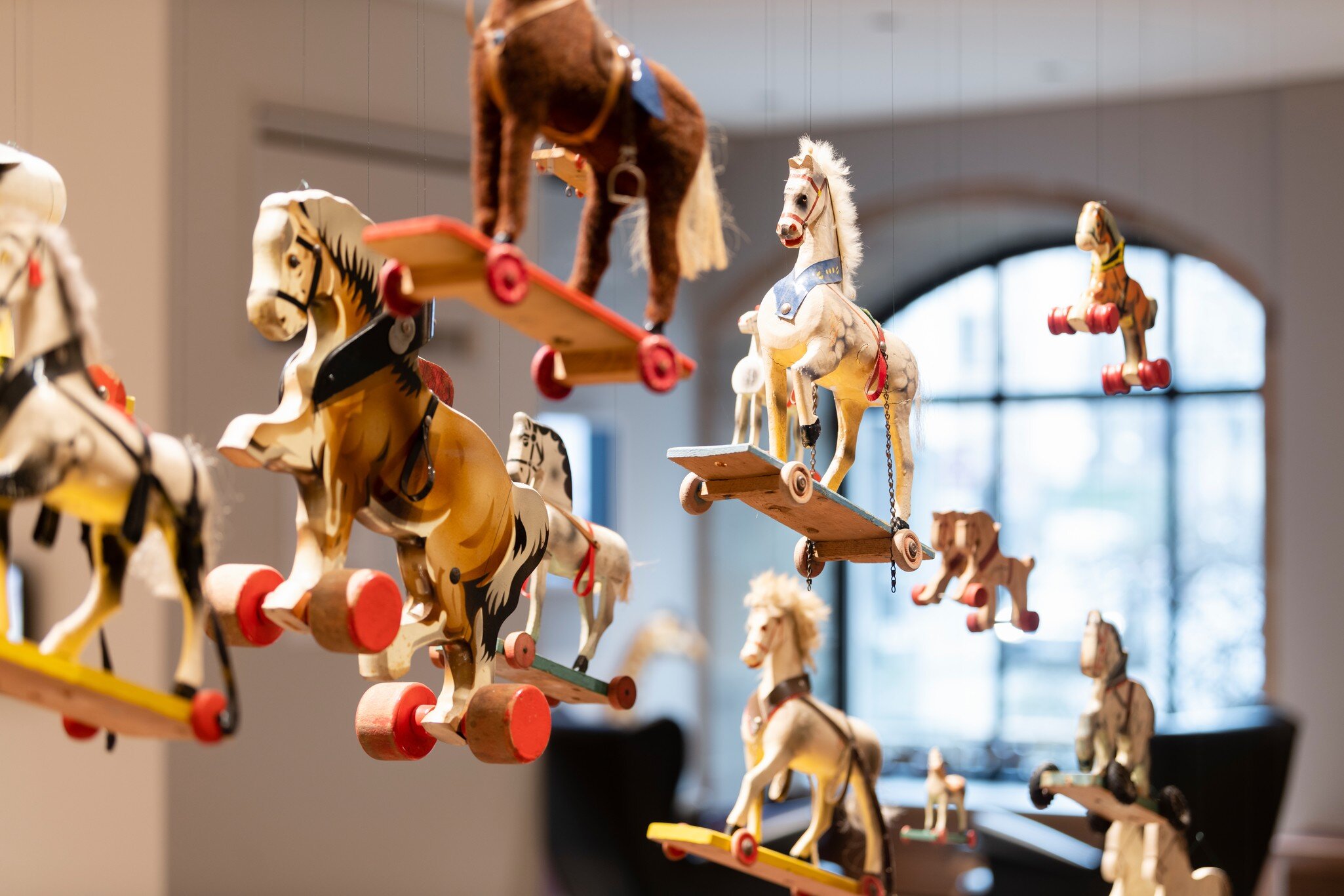 Close-up view of hanging toy horses at the Nuremberg Toy Museum or Spielzeugmuseum in Nuremberg, Germany. 