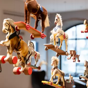 Close-up view of hanging toy horses at the Nuremberg Toy Museum or Spielzeugmuseum in Nuremberg, Germany. 