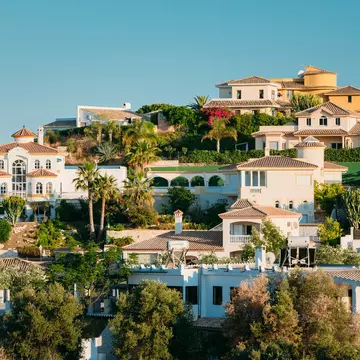 Aerial view of the white hilltop houses in the village of Mijas Pueblo on the Costa del Sol in Spain.