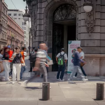 People walking in the Centro Histórico neighborhood, with historic buildings behind them