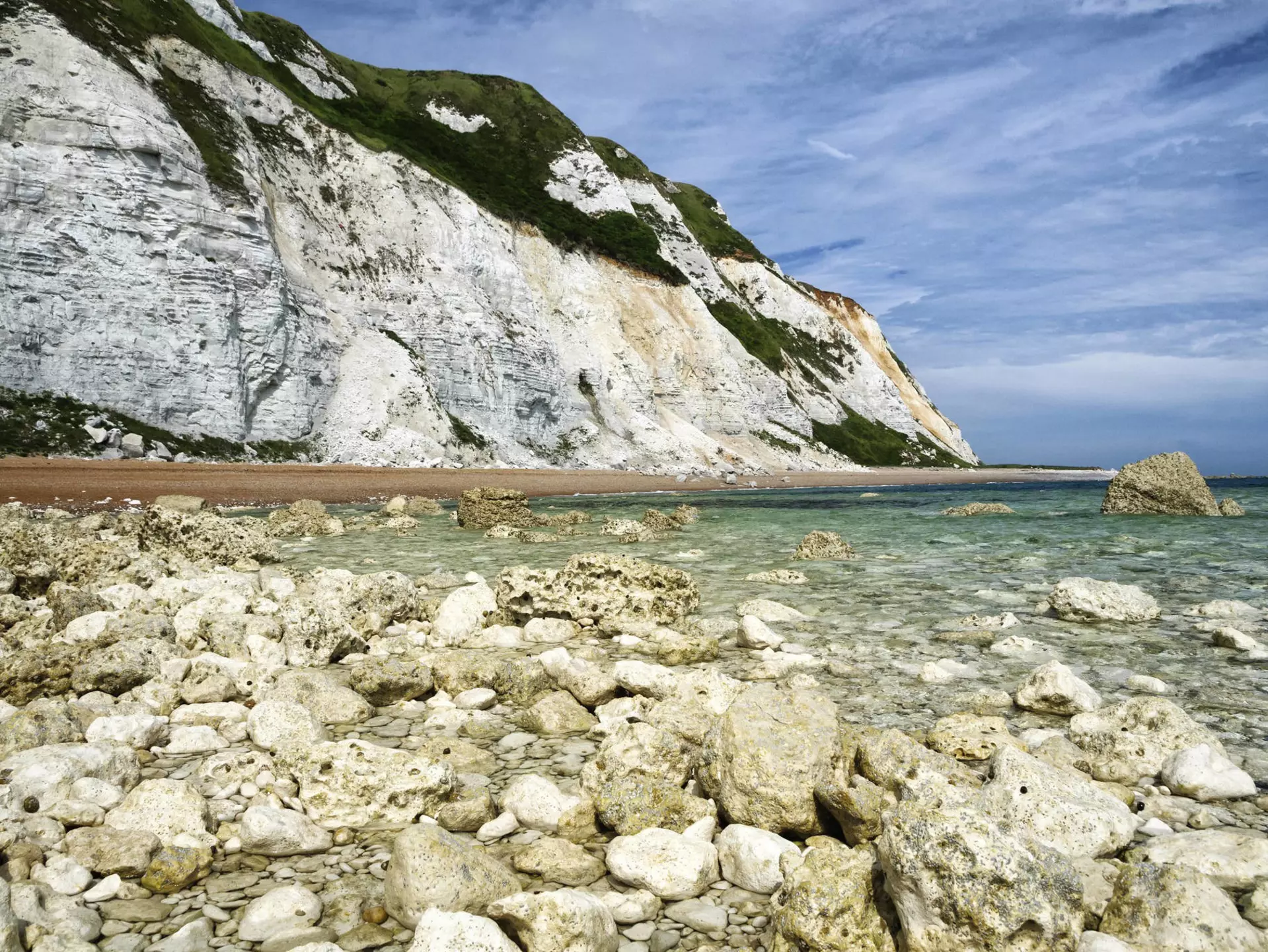 Dover chalk cliffs coastal erosion, as seen from the sea. ©Ryan Ladbrook/Shutterstock