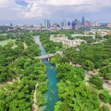 Aerial view Downtown from Barton Creek in Greenbelt at Zilker Metropolitan Park south Austin with summer blue cloud sky. Located at eastern edge of Hill Country, Austin the state capital of Texas, US.