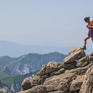 A woman walks across rocky terrain towards Daecheongbong peak at Seoraksan national park