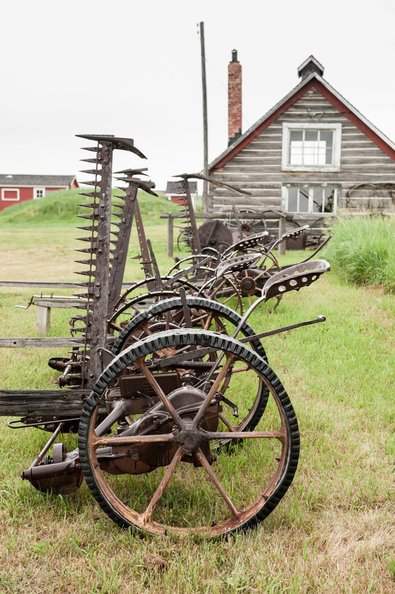 Old farm equipment and barn at Bar U Ranch in Alberta, Canada.