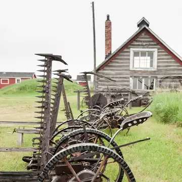 Old farm equipment and barn at Bar U Ranch in Alberta, Canada.