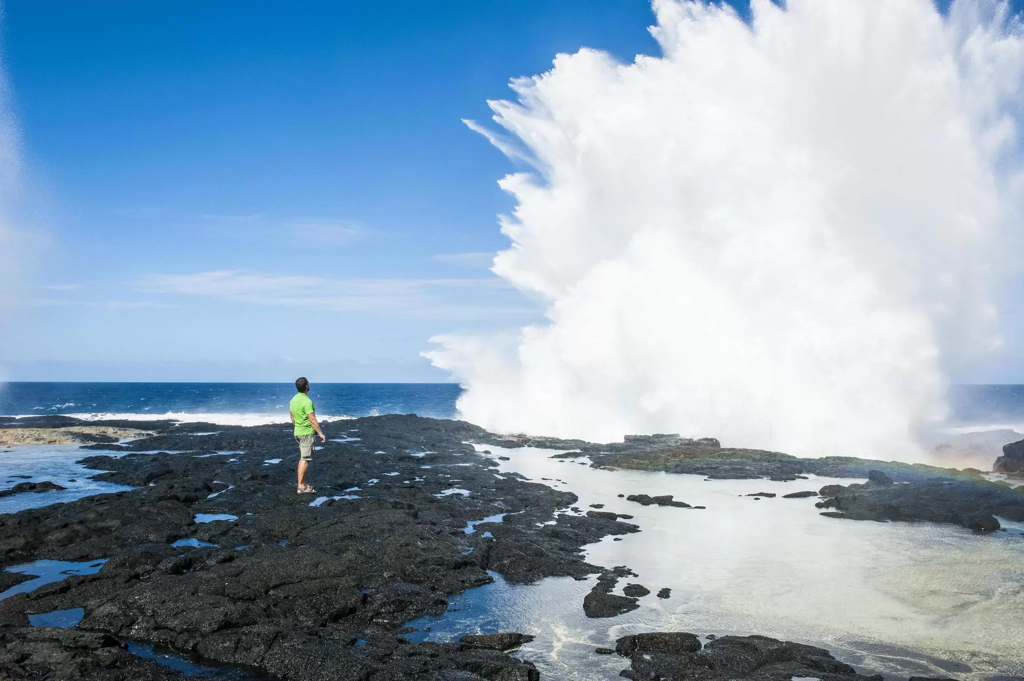 Tourist enjoying the huge waves in the Alofaaga blowholes on the south of Savaiʻi,  Samoa, South Pacific