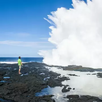 Tourist enjoying the huge waves in the Alofaaga blowholes on the south of Savaiʻi,  Samoa, South Pacific