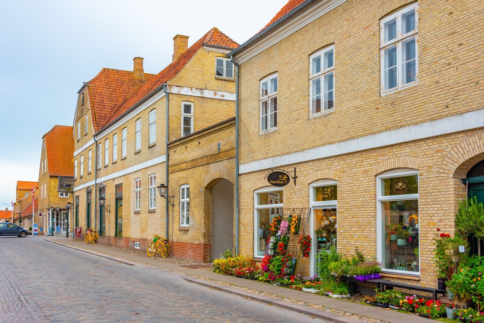 Traditional street with a flower shop in Danish town Christiansfeld, Denmark.