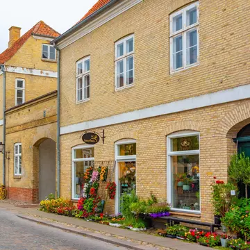 Traditional street with a flower shop in Danish town Christiansfeld, Denmark.