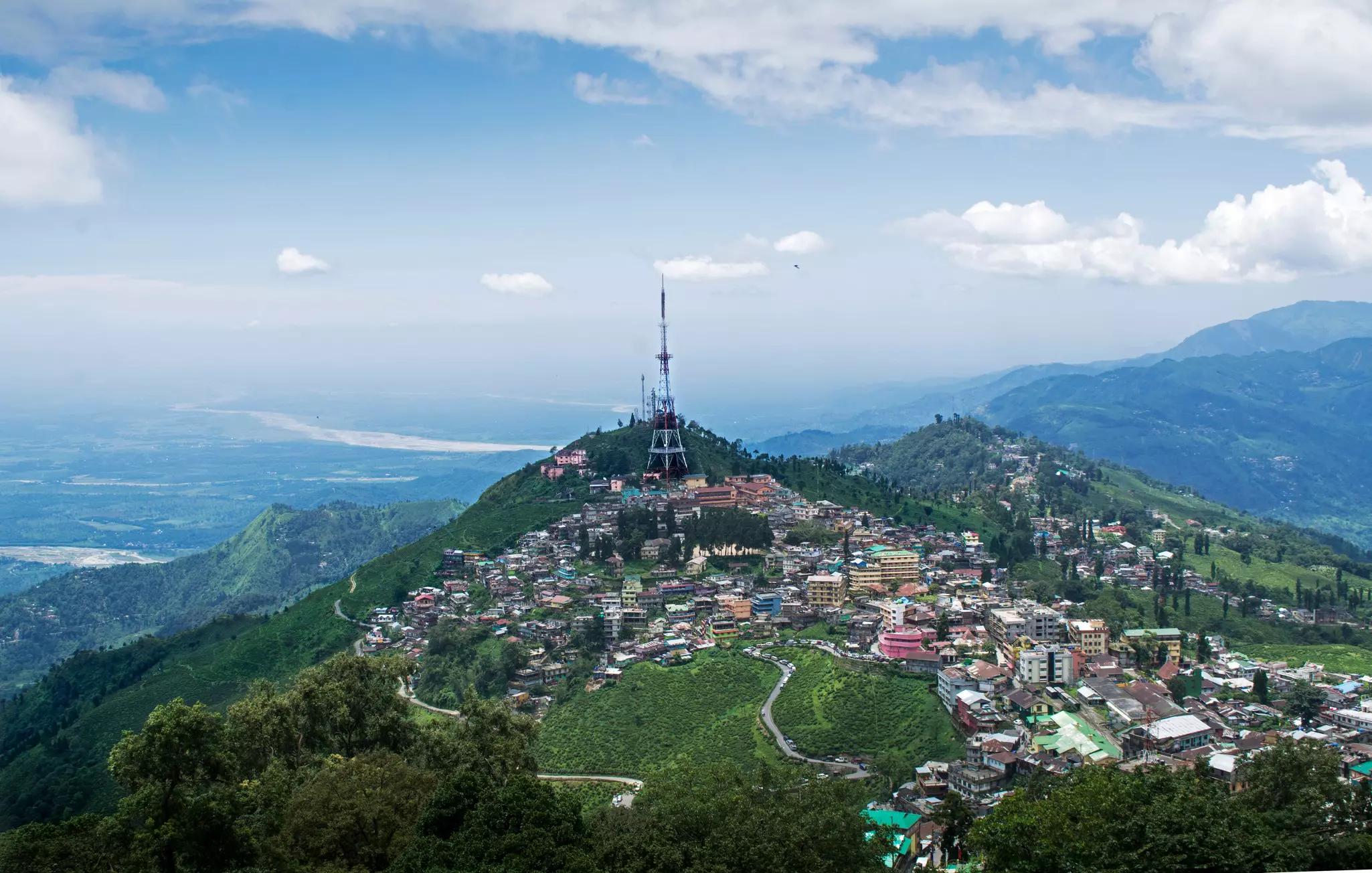A hilltop town surrounded by green rolling fields.
