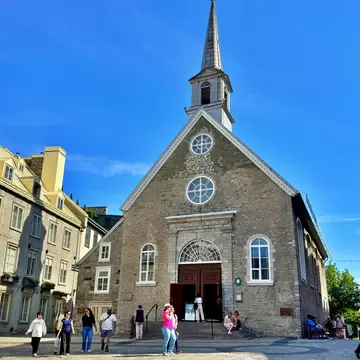 Quebec, Canada - Jun 25, 2025: Wide view of Notre Dame des Victoires Church in Place Royale surrounded by historic stone buildings and tourists visiting Old Quebec., License Type: media, Download Time: 2026-09-16T20:18:31.000Z, User: LP_NZhan, Editorial: true, purchase_order: 65050 - Digital Destinations and Articles, job: App Content, client: Lonely Planet App, other: Nadine Zhan 