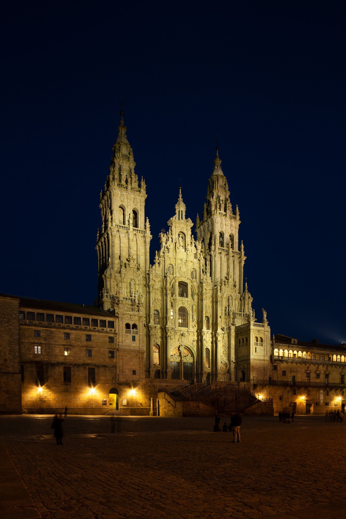 View of the facade of the Catedral de Santiago de Compostela at night in Spain.