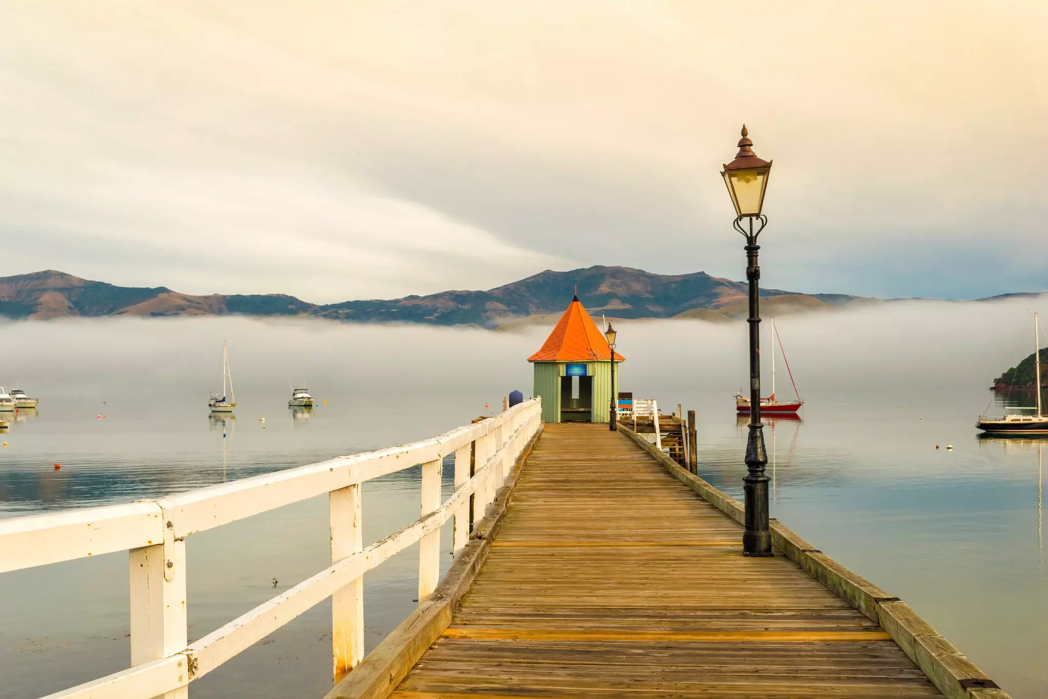 Landscape Scenery of Akaroa Harbour, New Zealand on the Morning Misty Day; Small Wharf.