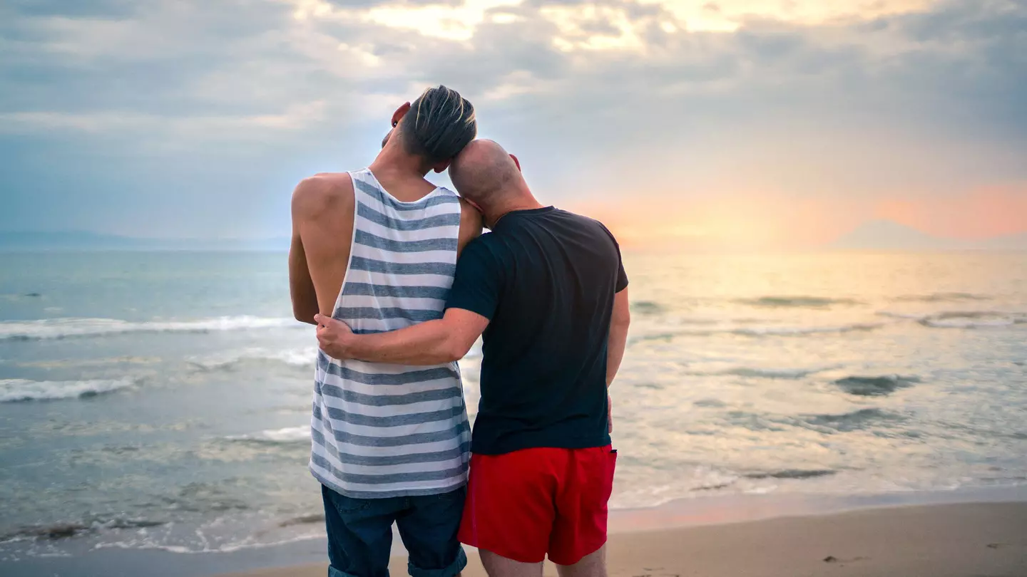 Couple seen from behind watching the sunset in Mykonos, Greece