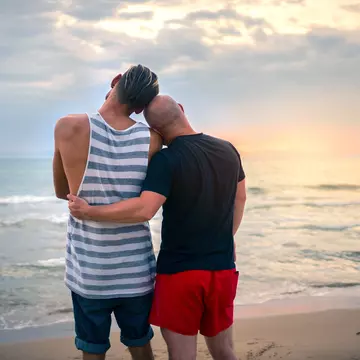 Couple seen from behind watching the sunset in Mykonos, Greece