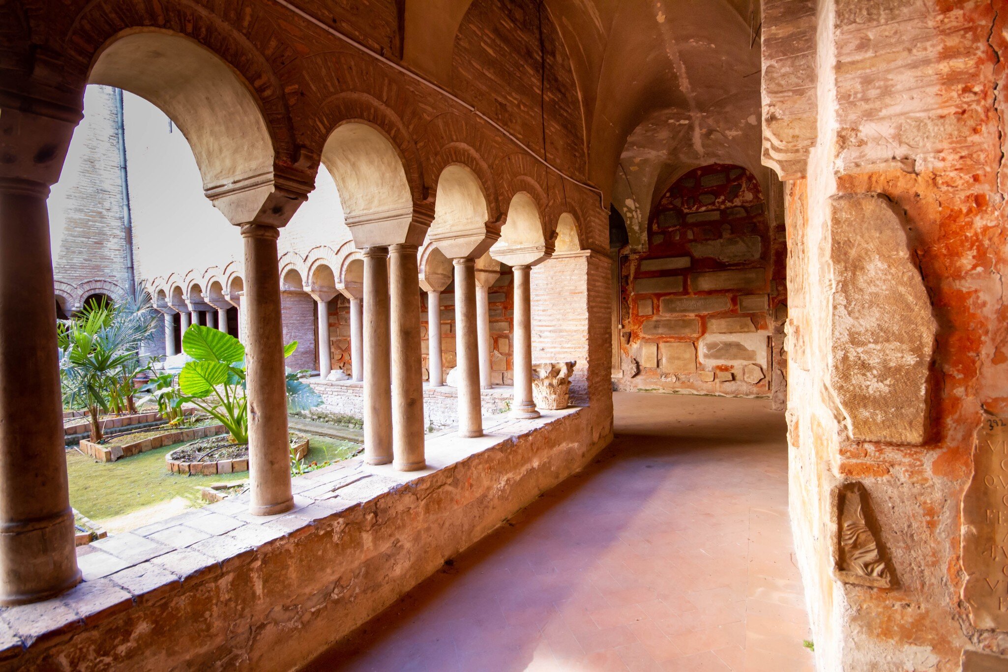 Rome, Italy- April 8,2021: The Cloister of The Basilica of San Lorenzo fuori le Mura.A square corridor built in the 12th century,Numerous sarcophagi and bas-reliefs are arranged along the walls; Shutterstock ID 1954131592; purchase_order: 65050; j...