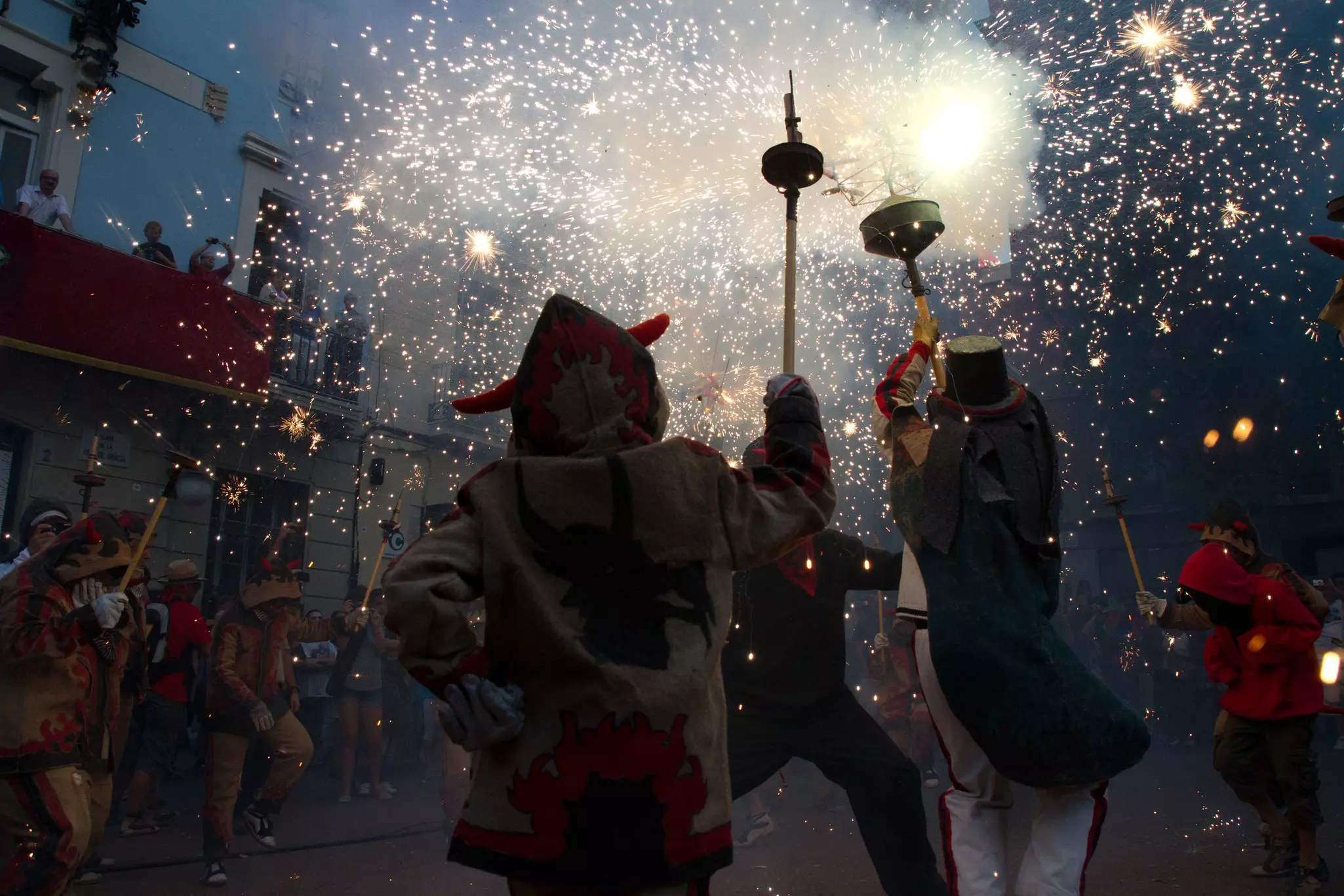Fire devils in the Children Fire-Run (Correfoc Infantil) as part of the Gracia Festival