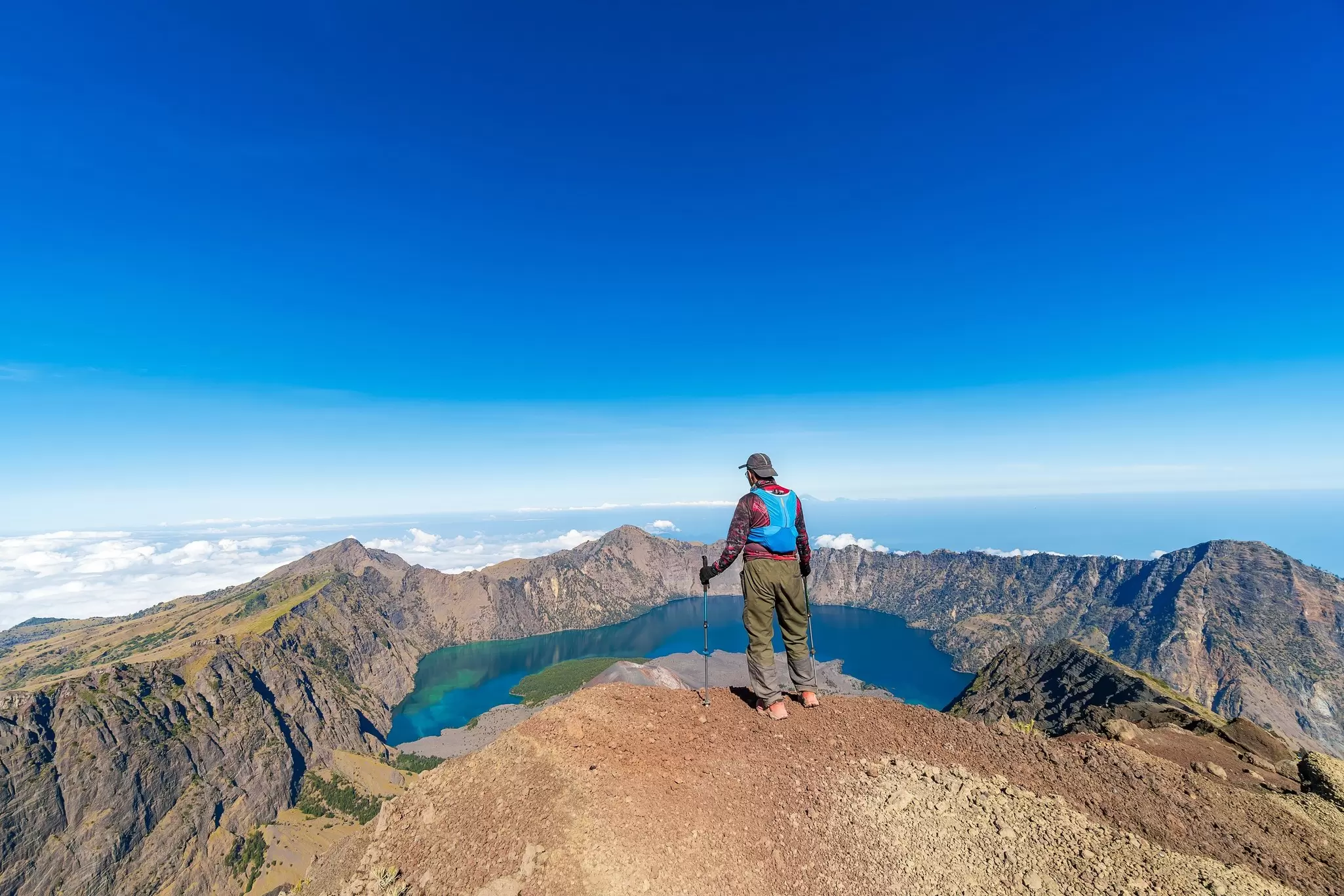 A hiker looks over the view at Gunung Rinjani on the island of Lombok, Indonesia.