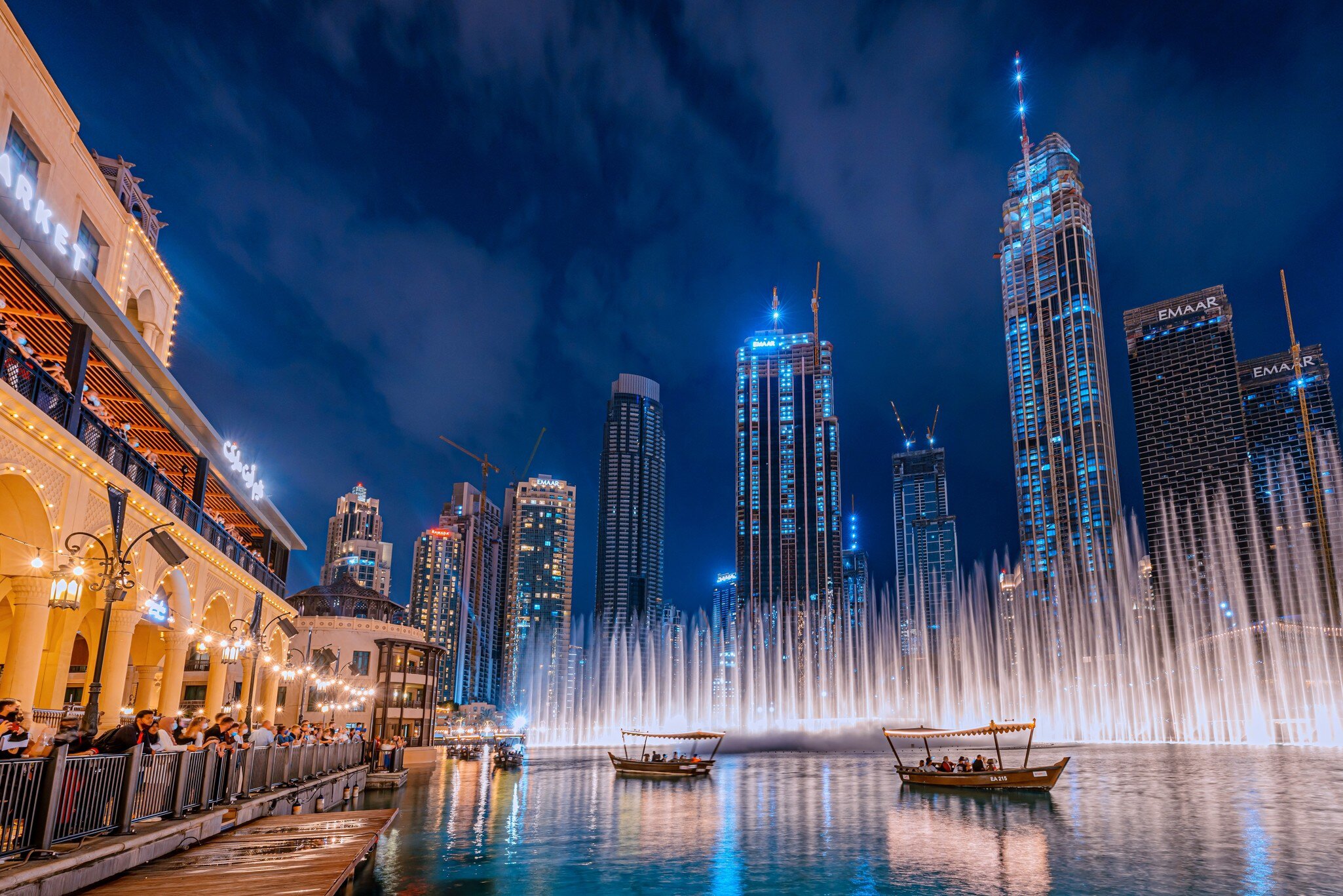 Dubai, United Arab Emirates - January 3, 2022: People enjoy a boat ride while watching a performance of the Dubai Fountain at night, with the skyscrapers of Dubai in the background., License Type: media, Download Time: 2026-05-21T16:52:43.000Z, User: lonelyplanetmedia, Editorial: true, purchase_order: 65050 - Digital Destinations and Articles, job: Comp Ingestion, client: Global Publishing WIP, other: Pia Peterson