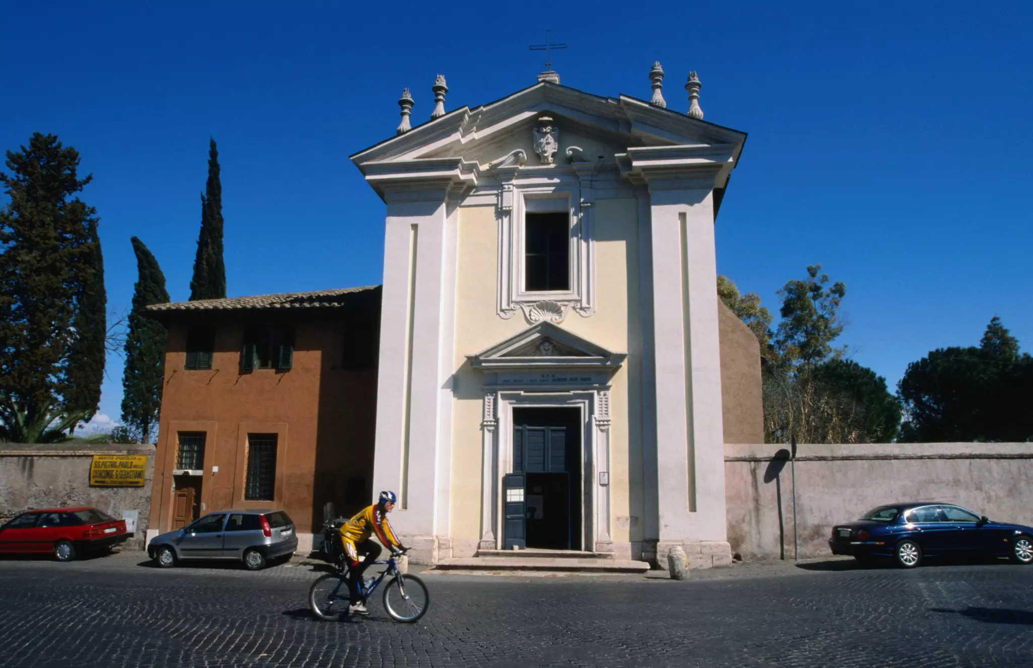 Cycling along a cobbled section of the Via Appia Antica in Rome. 