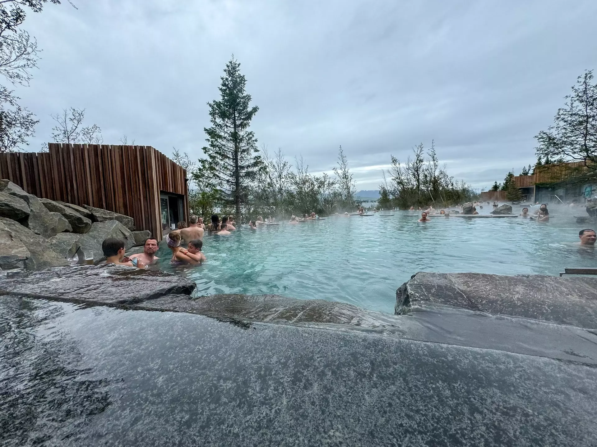 Akureyri, Iceland - August 9, 2024: People enjoying a soak in a thermal pool along the shores in Akureyri, Iceland, License Type: media, Download Time: 2025-11-24T19:12:57.000Z, User: comptonsheldon109, Editorial: true, purchase_order: 56530 - Guidebooks, job: Global Publishing WIP, client: Experience Iceland 2, other: Compton Sheldon
