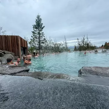 Akureyri, Iceland - August 9, 2024: People enjoying a soak in a thermal pool along the shores in Akureyri, Iceland, License Type: media, Download Time: 2025-11-24T19:12:57.000Z, User: comptonsheldon109, Editorial: true, purchase_order: 56530 - Guidebooks, job: Global Publishing WIP, client: Experience Iceland 2, other: Compton Sheldon