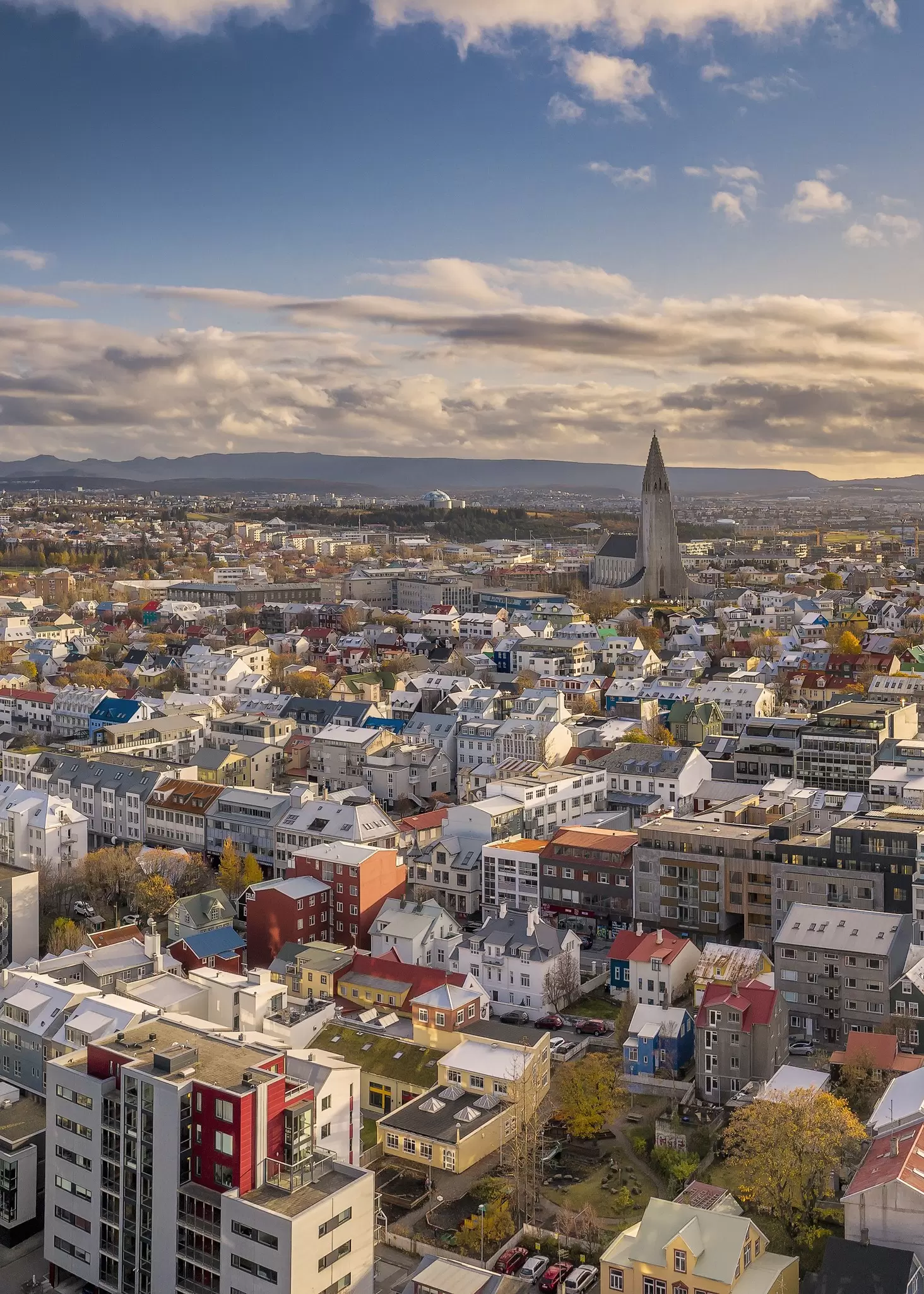 A low-rise city with a large modern church spire.