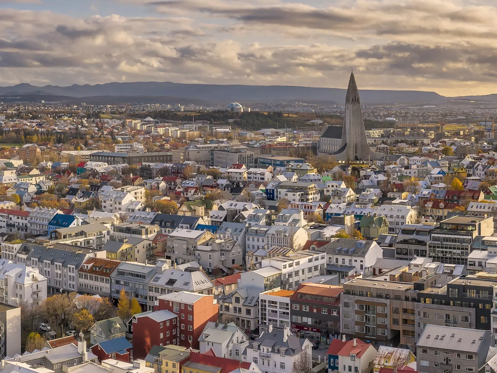A low-rise city with a large modern church spire.