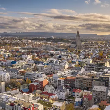 A low-rise city with a large modern church spire.