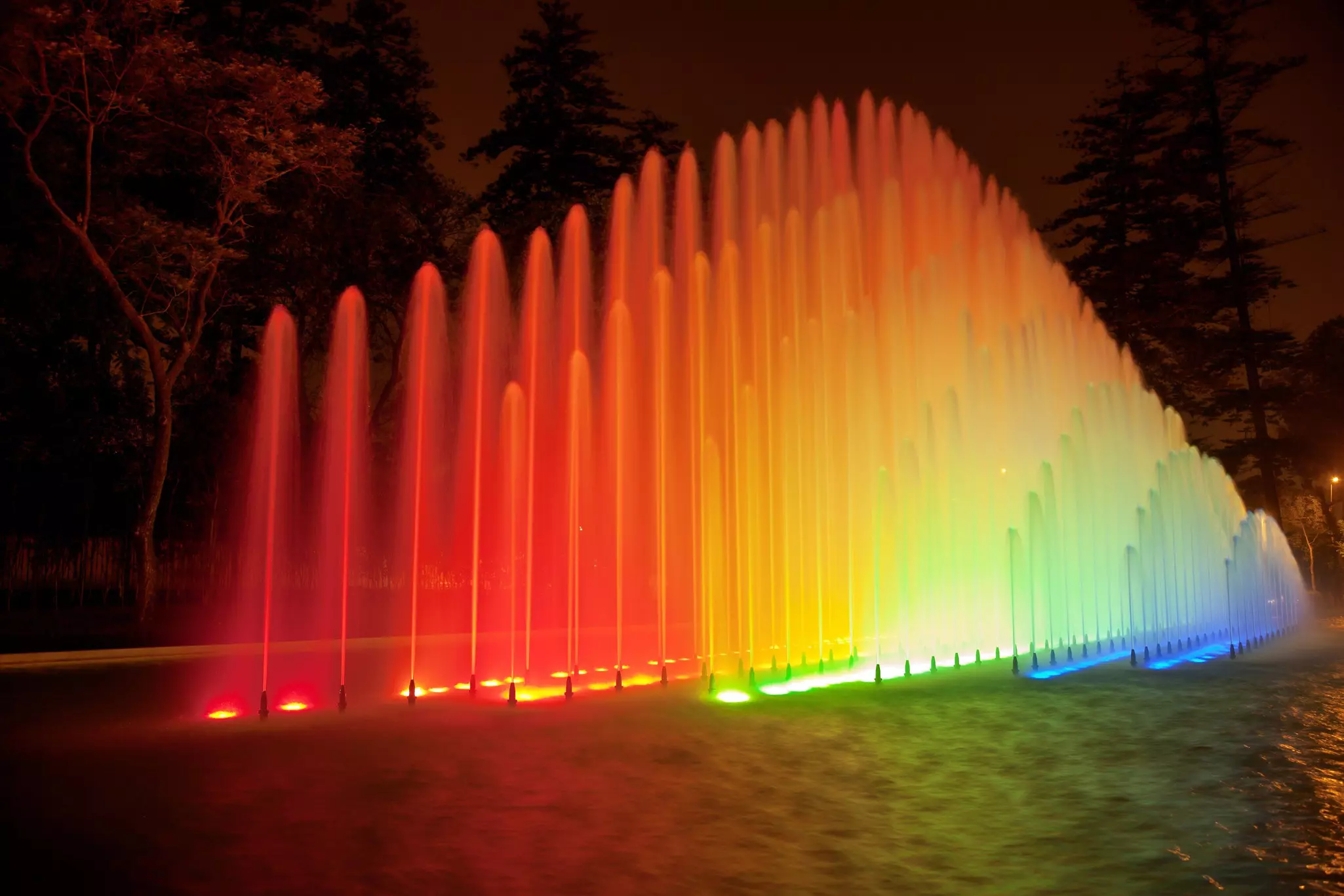 Water fountains lit up with bright colors at night in the Magic Water Circuit Park, Lima ©jirivondrous/Getty Images