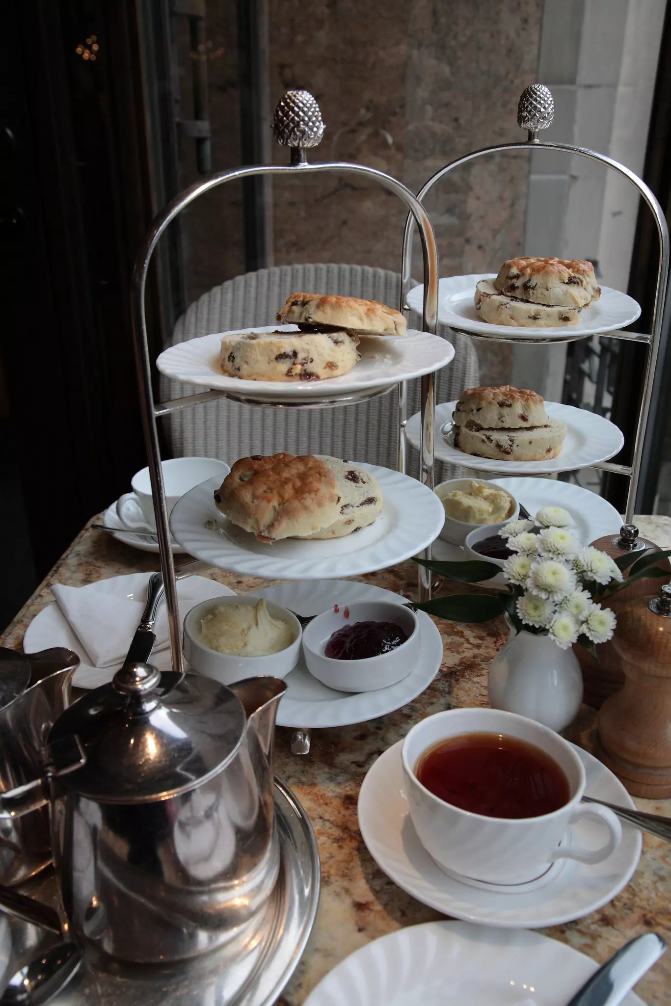 Traditional British afternoon tea with scones, jam, cream, and a cup of tea on table from a famous local cafe tea rooms in York, Yorkshire, England, UK