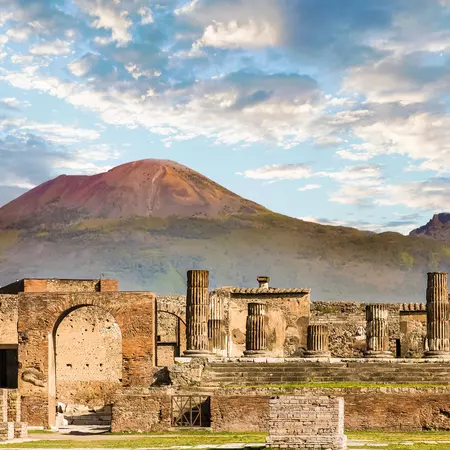 The ruins of Pompeii in the foreground with Mt Vesuvius in the background. 