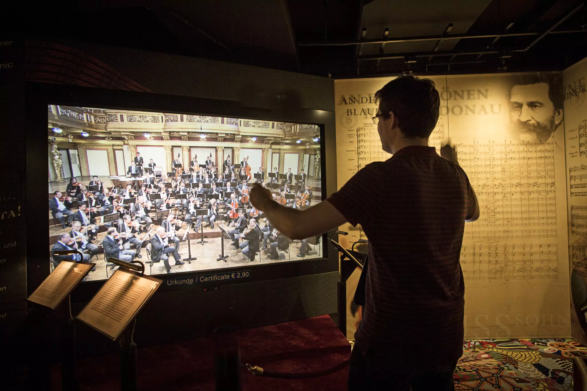 A person conducts a virtual orchestra at Haus der Musik in Vienna.