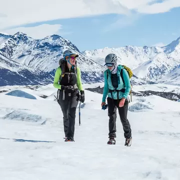 Two female glacier guides chatting while they trek across the Matanuska Glacier. Hiking in the Chugach Mountains on alpine glacier.  License Type: media  Download Time: 2024-02-14T02:17:53.000Z  User: FergalCo  Is Editorial: No  purchase_order: