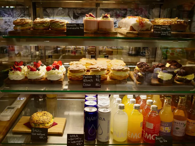 Shelves of pastries and drinks behind glass