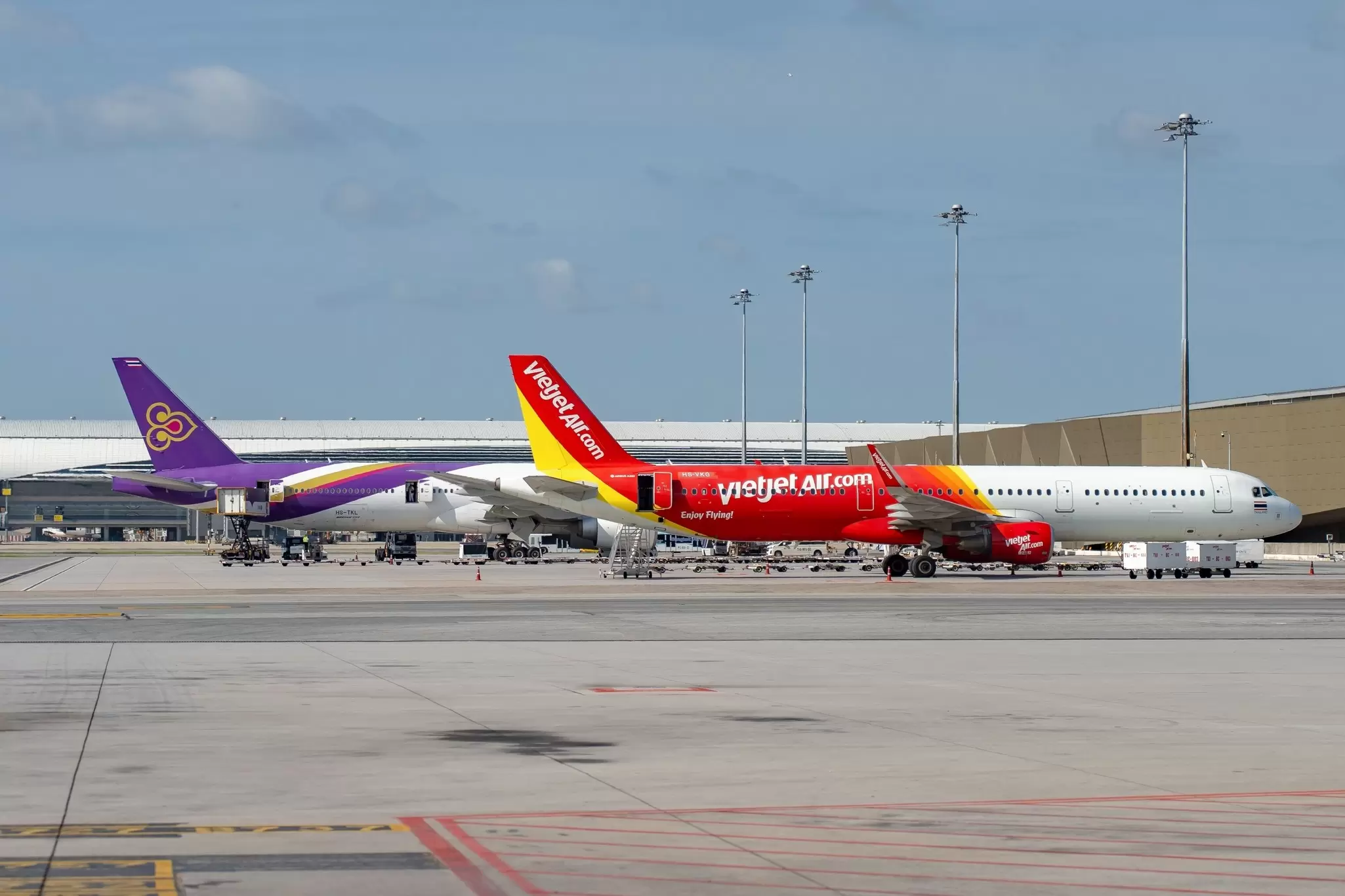 Two planes prepping for boarding at Suvarnabhumi Airport in Bangkok, Thailand. 