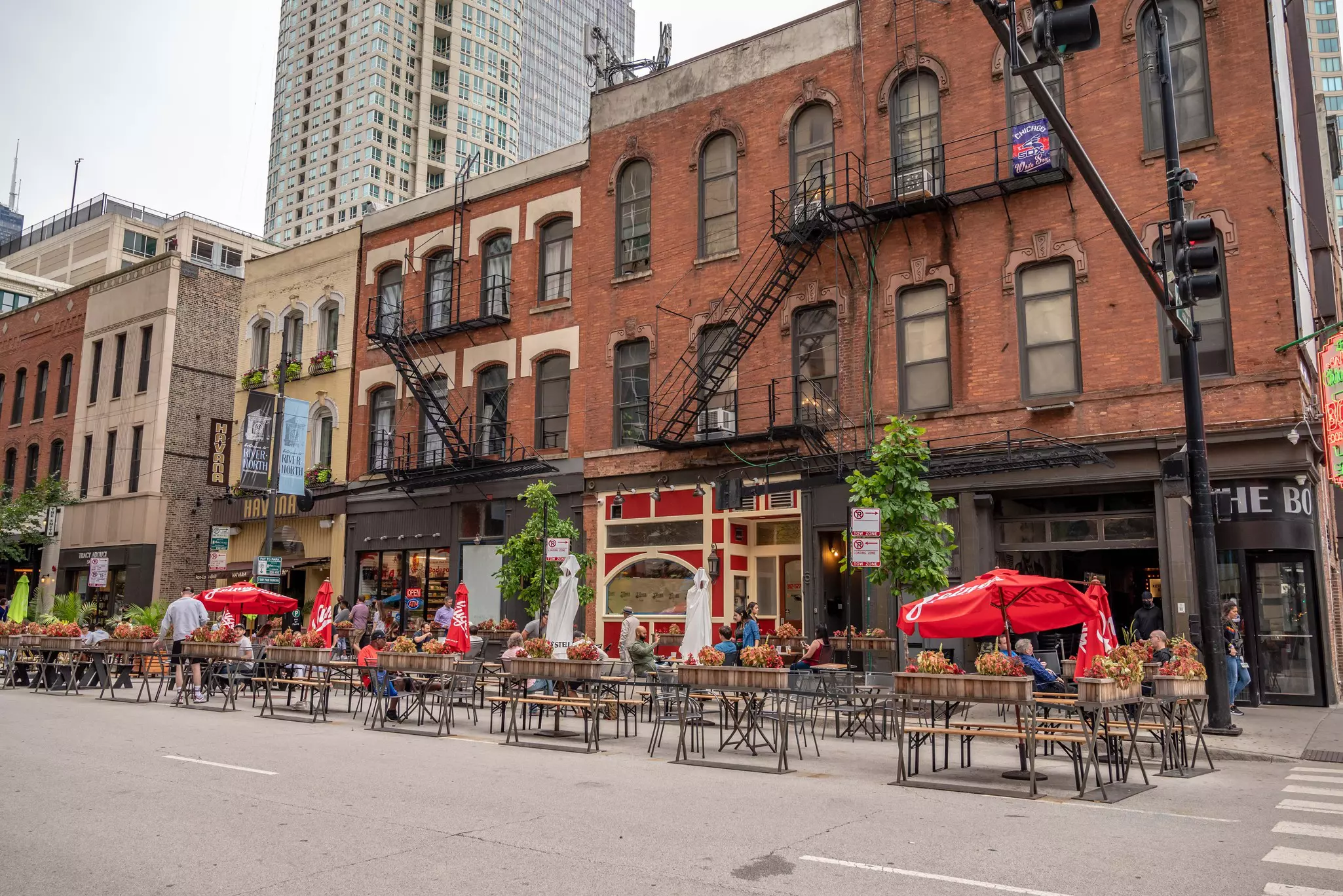 Chicago, IL - August 1, 2021: People dine out in the street on Clark, in River Downtown, in summer.