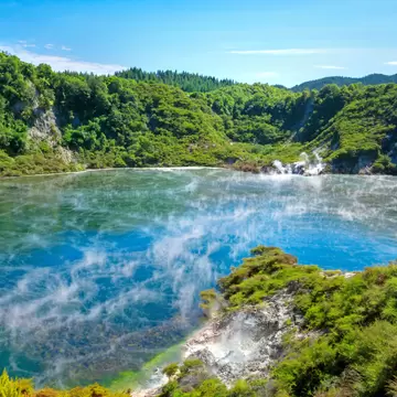 Hot Frying Pan Lake with clouds of steam in Echo Crater at Waimangu volcanic valley;
Geothermal landscape in Rotorua, New Zealand