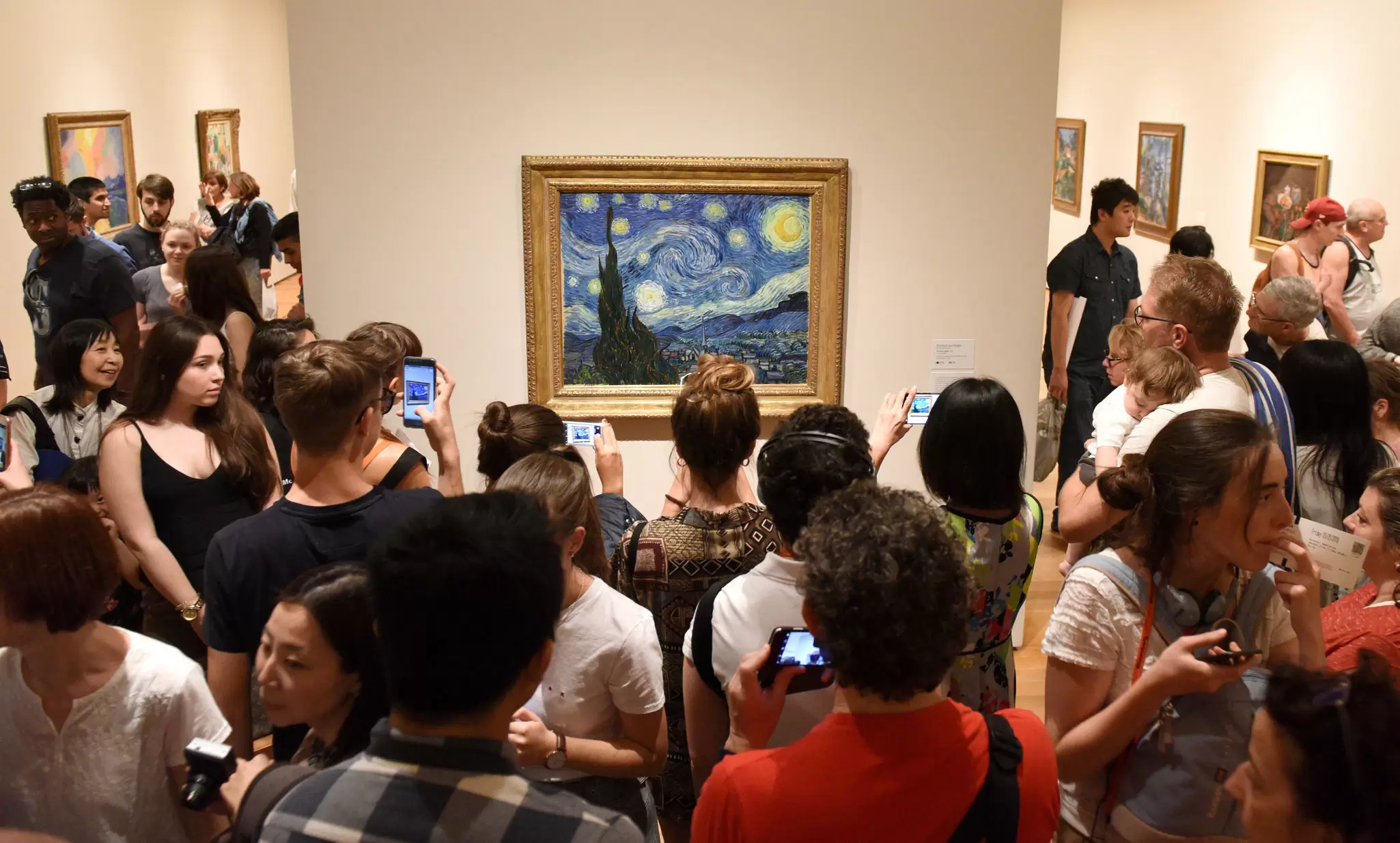 May 25, 2018: Crowd of people surround the Starry Night painting by Vincent van Gogh inside the Museum of Modern Art.