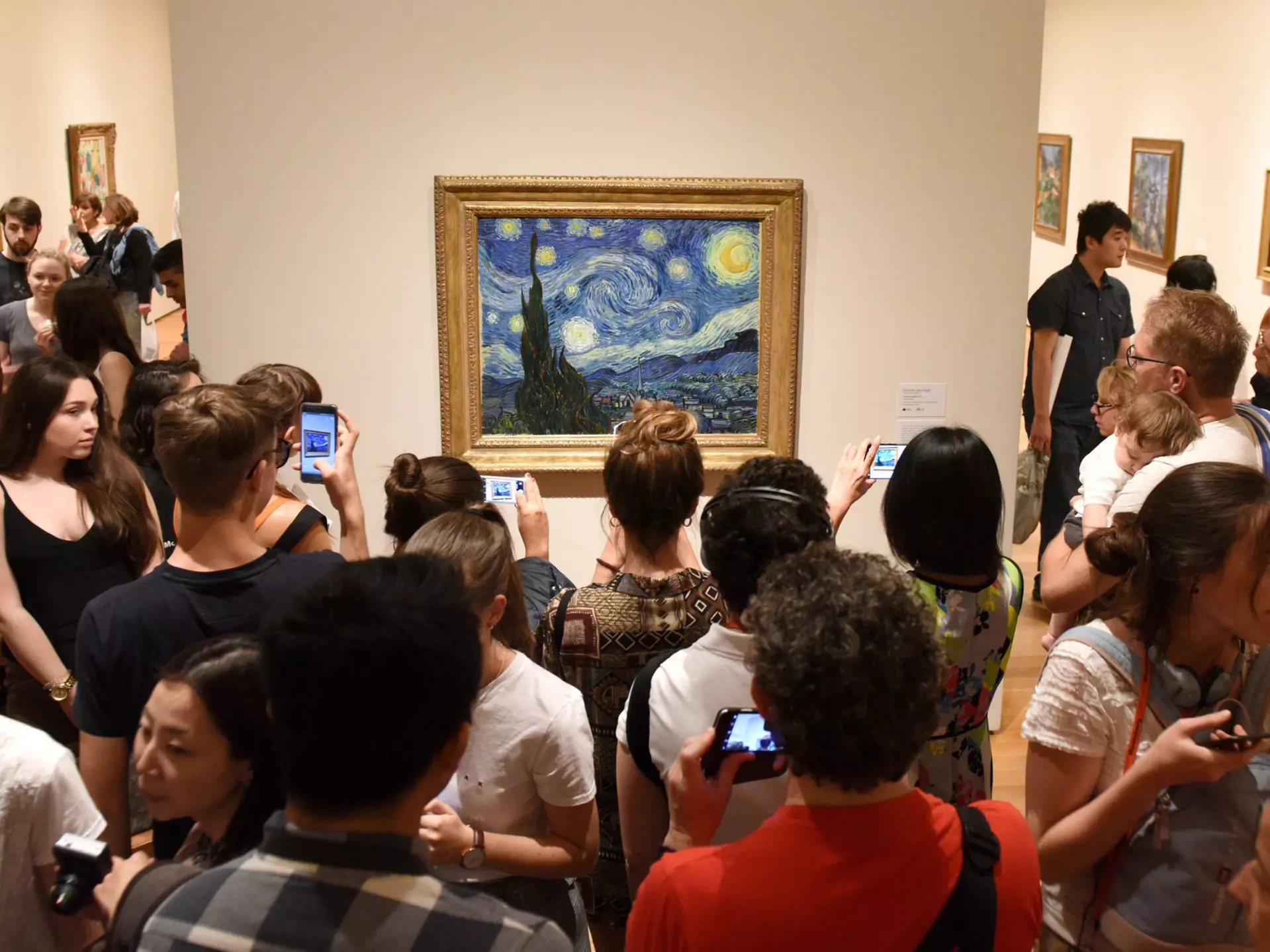 May 25, 2018: Crowd of people surround the Starry Night painting by Vincent van Gogh inside the Museum of Modern Art.