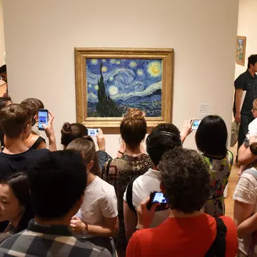 May 25, 2018: Crowd of people surround the Starry Night painting by Vincent van Gogh inside the Museum of Modern Art.