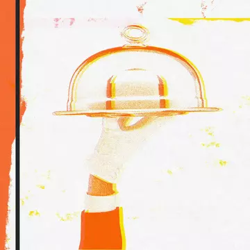A gloved hand holds a tray with a dome over it aloft