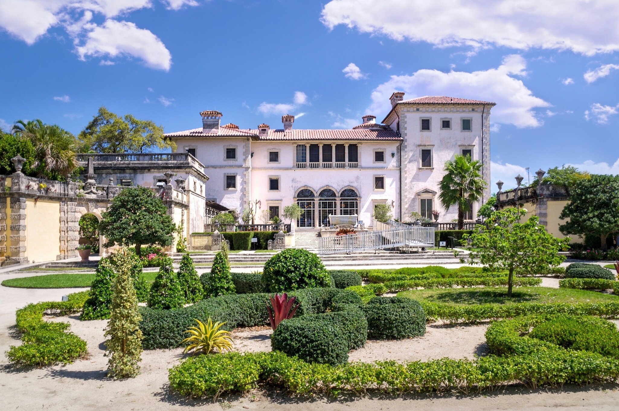 View of the garden and main building of the Villa Vizcaya Museum on a sunny day in Miami, Florida.