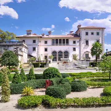 View of the garden and main building of the Villa Vizcaya Museum on a sunny day in Miami, Florida.