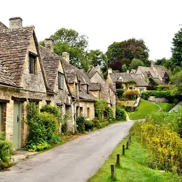 Houses of Arlington Row in the village of Bibury, England; Shutterstock ID 172701119; your: Sloane Tucker; gl: 65050; netsuite: Online Editorial; full: Cotswolds Things to Do article