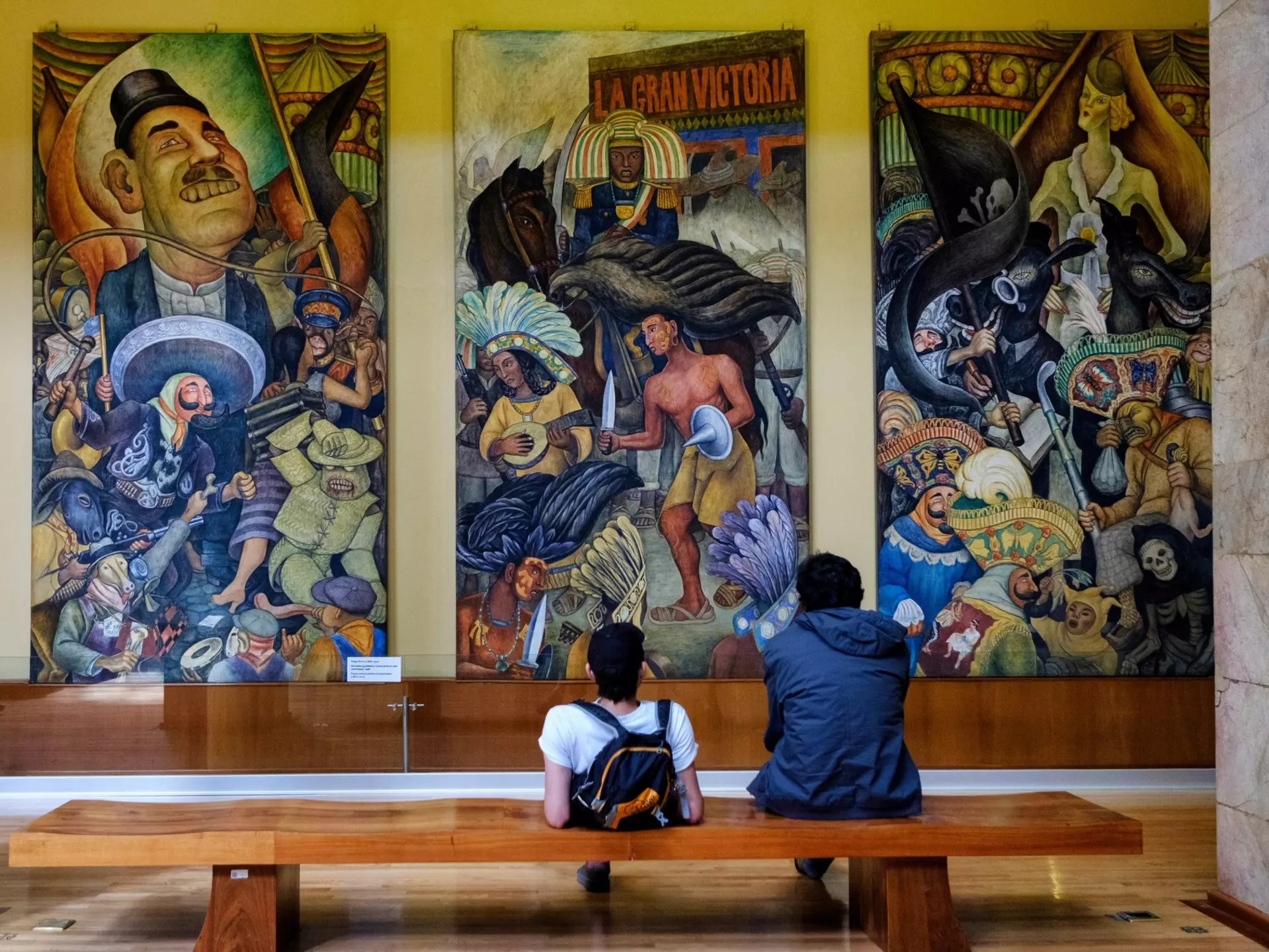 Visitors at the Palacio de Bellas Artes in Mexico City look at Diego Rivera’s 'Carnaval de la vida mexicana' mural.