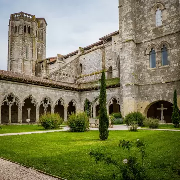 The medieval cloister and tower of the Saint Pierre collegial church in La Romieu, south of France (Gers). 