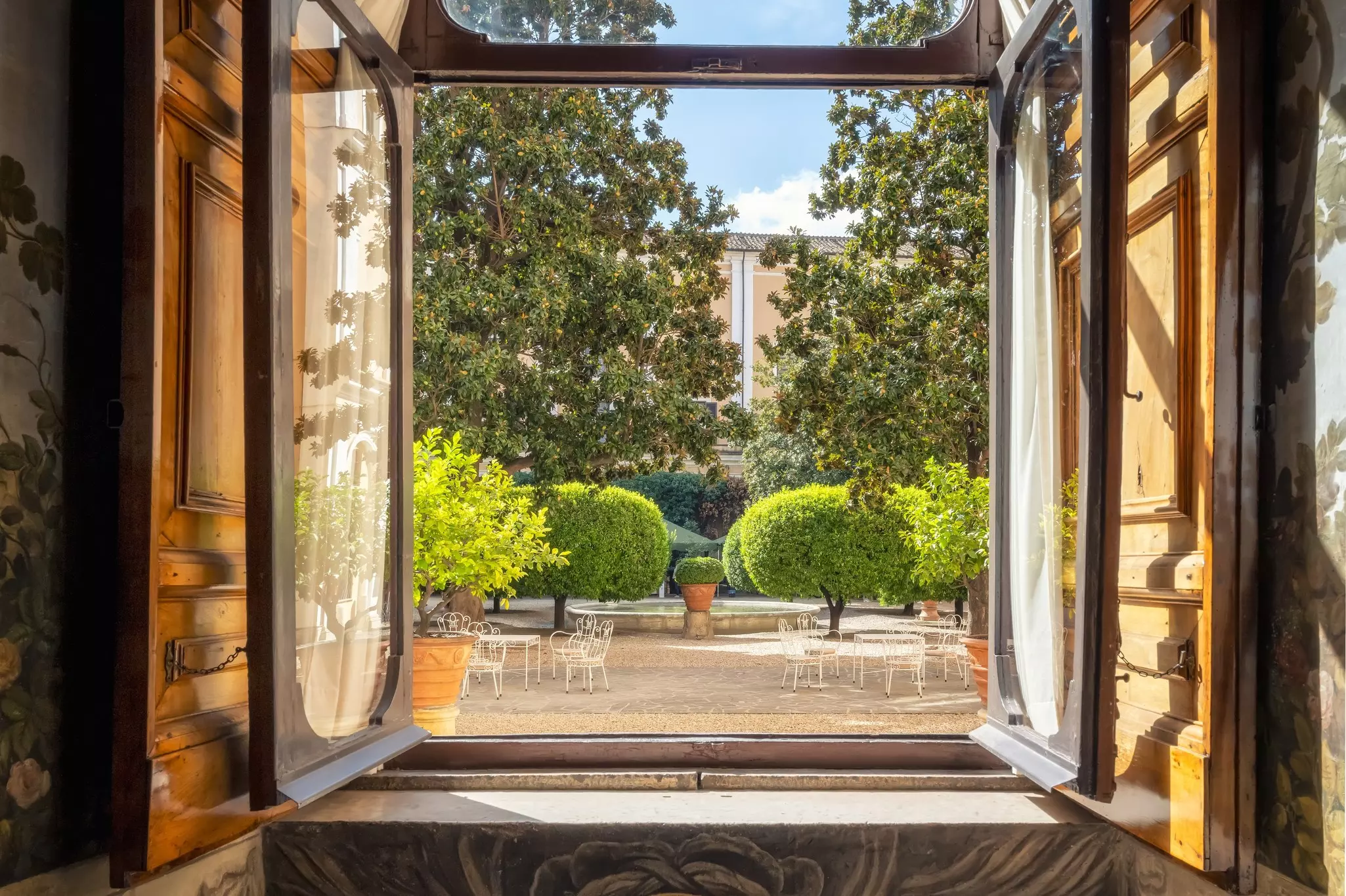 Looking out the window to a courtyard in the interior of the Palazzo Colonna in Rome, Italy