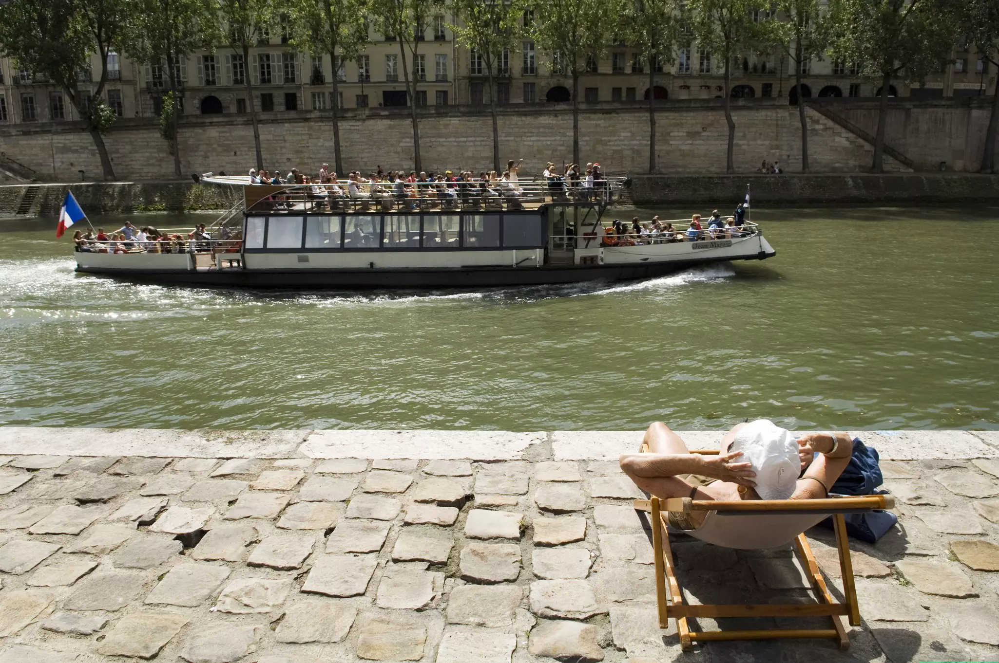 Sun worshipper on banks of River Siene at the Paris Plage (Paris beach).