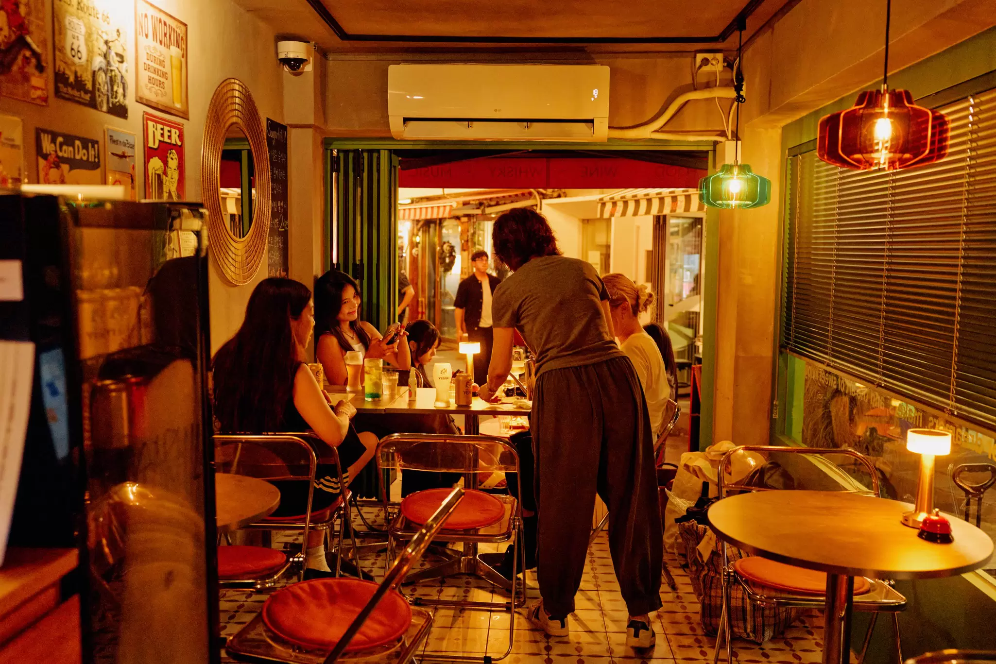 A group sits at a table in a warmly lit restaurant with 